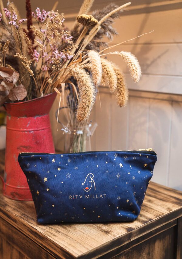 Rita Millat Blue Makeup Bag with gold zip and illustrated design